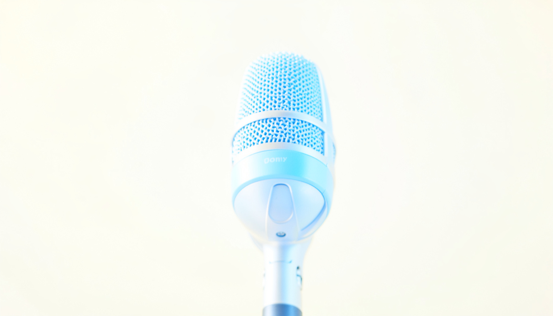 A bright, airy high-key photograph of a softly glowing studio microphone against a clean cream background